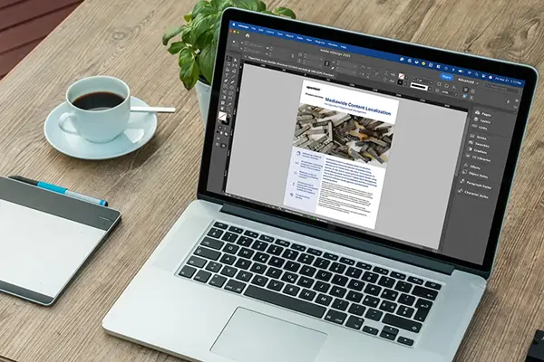 A workspace with a laptop displaying a medical consent localization document, alongside a coffee cup, a notepad with a pen, and a small plant on a wooden table, highlighting a productive healthcare documentation environment.