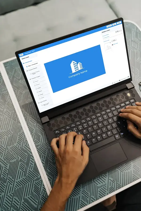 A laptop featuring a real estate property management software interface, showing options for property details, photos, layouts, and agent contact, placed on a patterned table for a professional working setup.